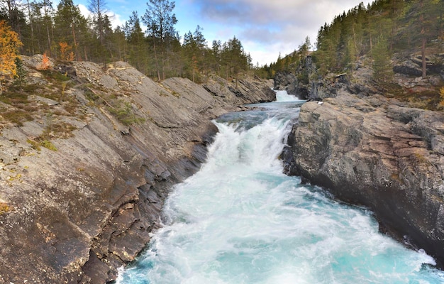 Water of a straem flowing between the rocks in Norway