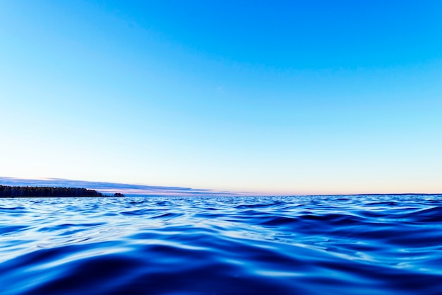 Water surface. View of a Crystal clear sea water texture. Small waves. Water reflection