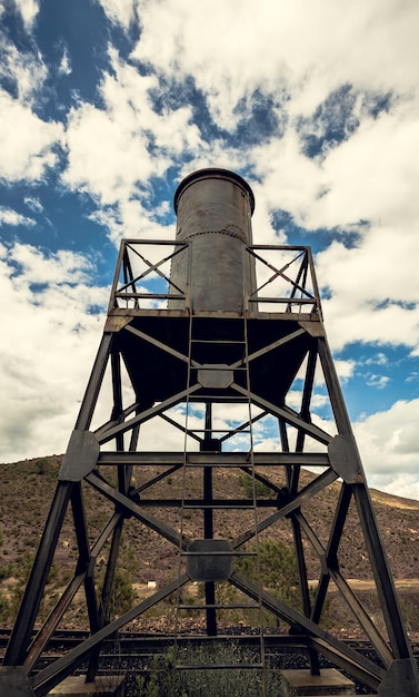 Water tank in the iron structure with the sky and mountain 