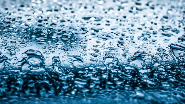 Water texture abstract background aqua drops on blue glass as science macro element rainy weather and nature surface art backdrop for environmental brand design