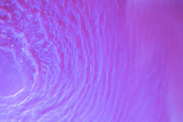 Water texture splashes and waves top view with bubbles in neon light