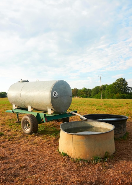 Water trough for drinking for cows cattle in the field, Franche Comte, France.