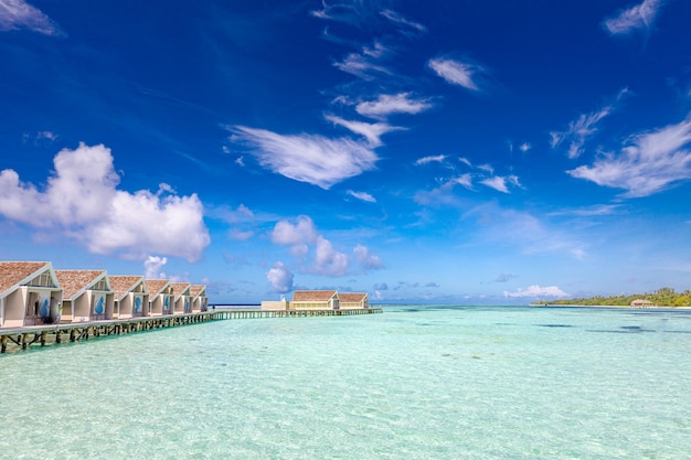 Water villas and wooden bridge at Tropical beach in the Maldives at summer day Perfect wooden pier