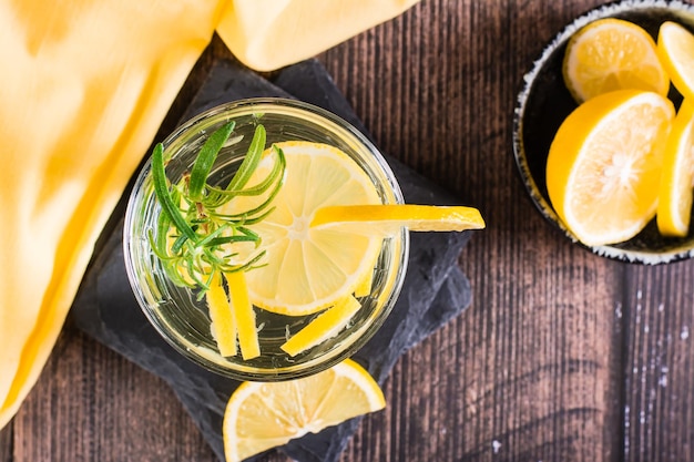 Water with lemon and rosemary in glasses on the table Detox drink Top view Closeup