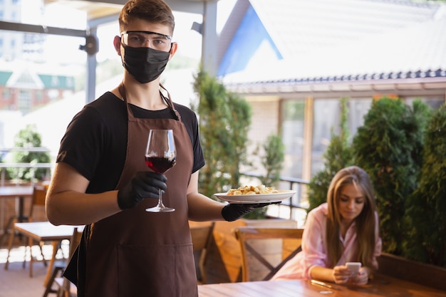 Water working with face mask in restaurant, coronavirus outbreak