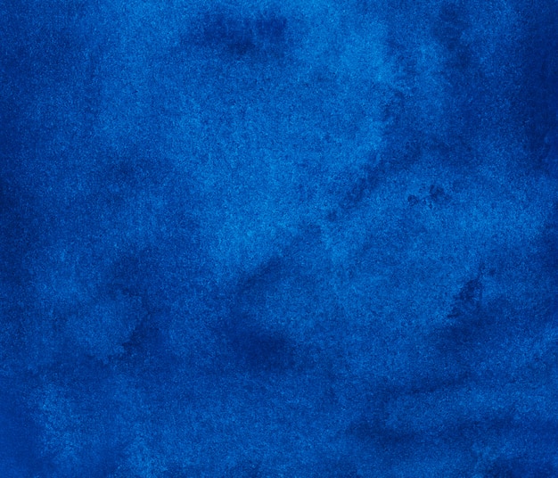 Watercolor deep blue background texture. Hand painted watercolour background. Sky blue stains on paper.