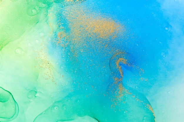 Watercolor green blue and gold abstract stains background ink gradient texture