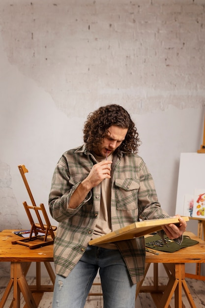 Watercolor painting artist in his studio