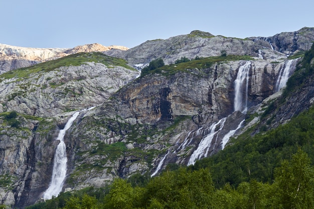 Waterfall in the Caucasus mountains, melting glacier ridge Arkhyz, Sofia waterfalls