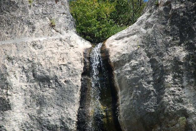 Waterfall in a mountain on a background of blue sky