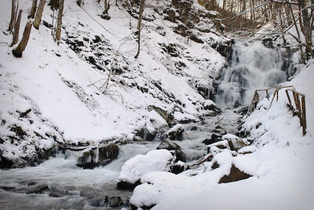 Waterfall mountain river in a forest in winter