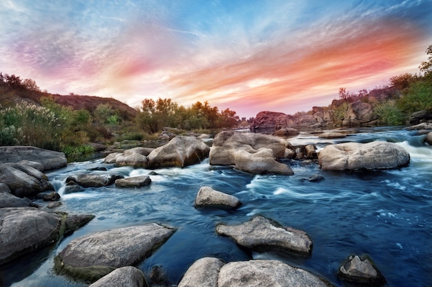 Waterfall on mountain river with gray stones