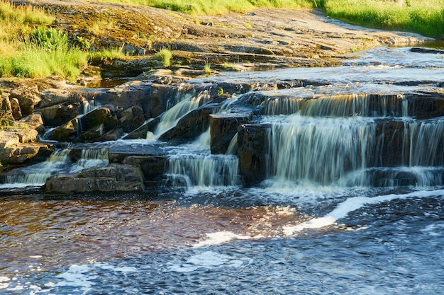 Waterfall in the mountains on the river among the forest