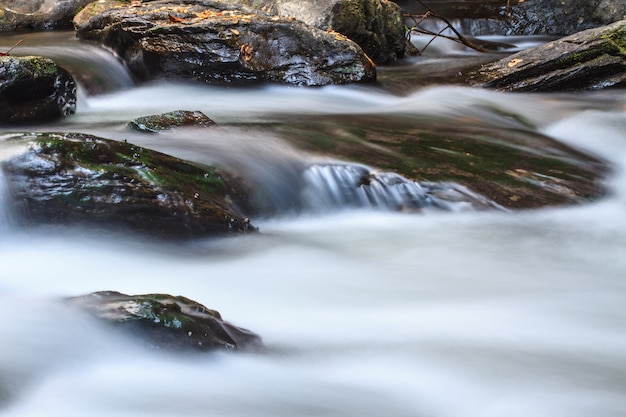 Waterfall and rocks covered with moss