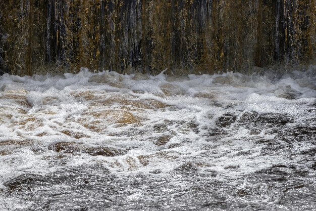 Waterfall with bubbling and foaming water