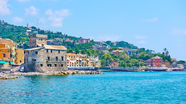 Waterfront with medieval Rapallo Castle on the sea shore, Rapallo, Italy