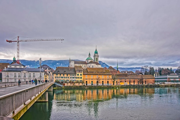 Waterfront with St Ursus Cathedral and Palais Besenval. Solothurn is the capital of Solothurn canton in Switzerland. It is located on the banks of Aare and on the foot of Weissenstein Jura mountains