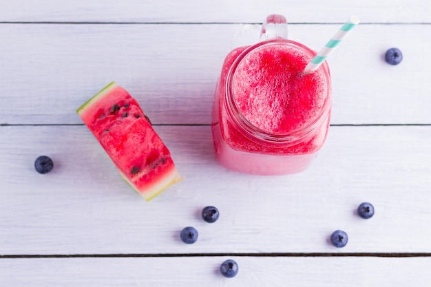 Watermelon drink in mason jars with slices of watermelon Watermelon smoothies and blueberries