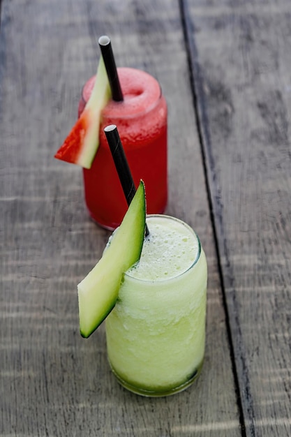 watermelon and green melon juice cuisine with grey wooden background