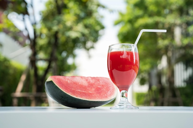 Watermelon juice and watermelon slices on the natural background