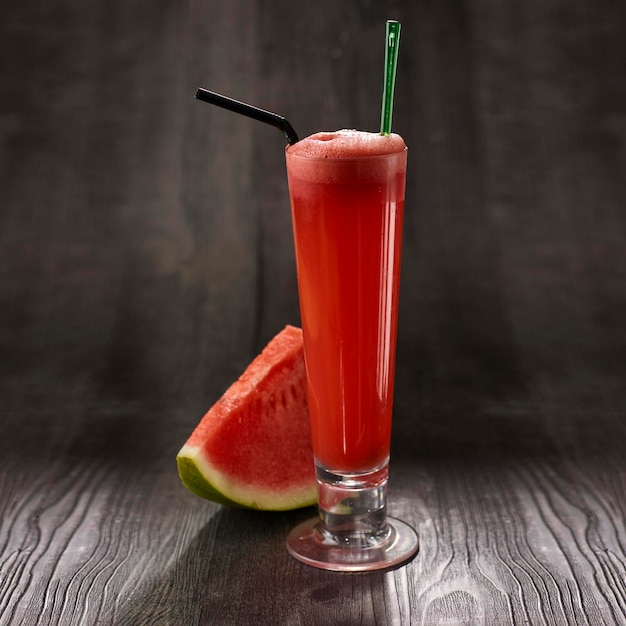 Watermelon Juice with straw served in glass isolated on table side view healthy morning drink