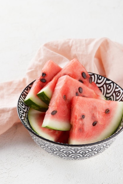 Watermelon slices with seeds on gray background fresh juicy fruit on a plate