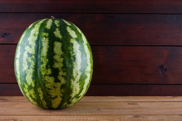 Watermelon on wooden boards Whole watermelon on wooden background Healthy food for vegan Copy space