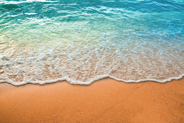 Wave of blue ocean on sandy beach. Background.