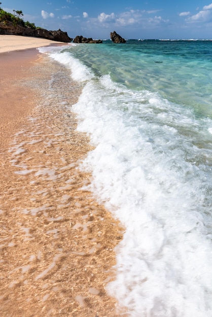 Wave breaking along the shore white foam