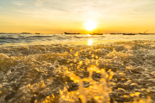 Wave hitting the beach and Reflect sunlight During sunset