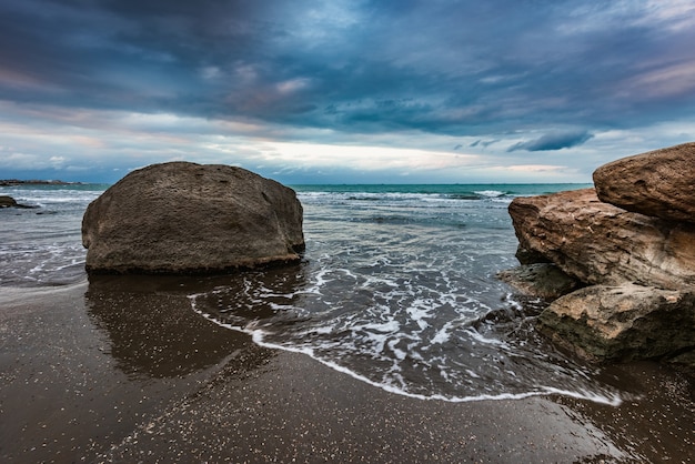 Wave splashing at the rocks freshness on beach