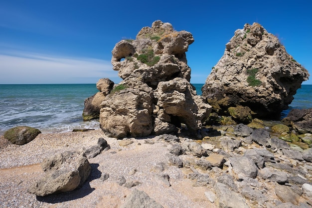 Waves beat against the coastal sea rock Rocks beach and beautiful turquoise sea water Exotic beach Beautiful landscape Composition of nature