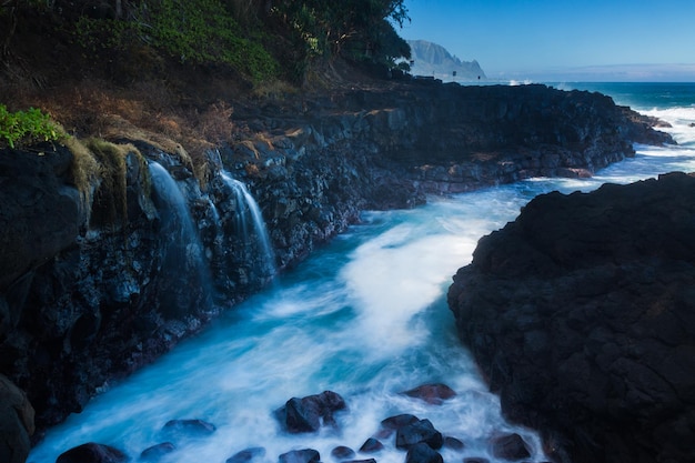 Waves hit rocks at Queens Bath Kauai