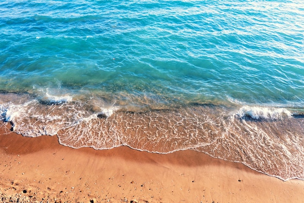 Waves roll on the sandy beach Natural background