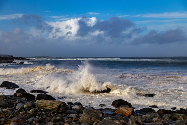 Waves of the sea crashing on the rocks at the shore