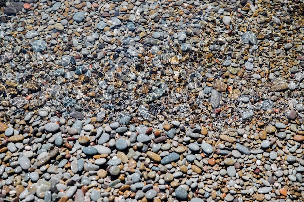 Waves on the seashore A clear sunny day Clear clean sea water Holidays on the coast Natural background and texture