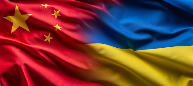 Waving flag concept of Ukraine and China symbolising political connection