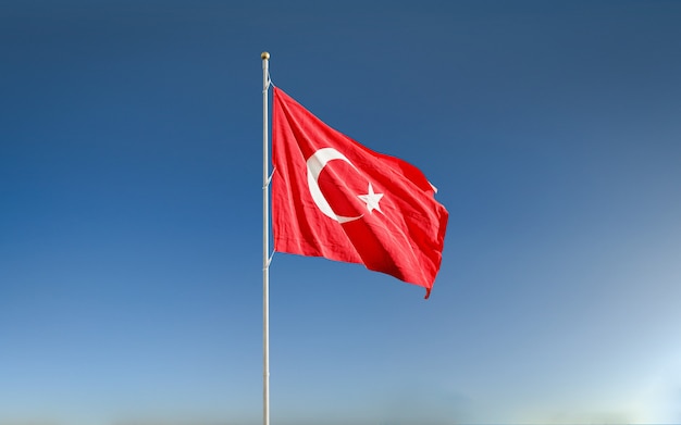 Waving Turkish flag in the blue sky