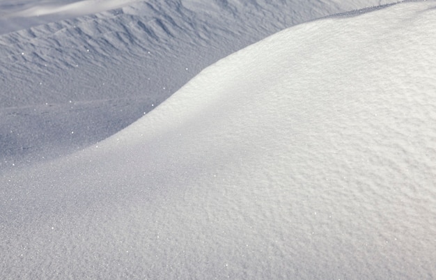 Wavy and hilly surface of Deep snow drifts in the winter season, beautiful nature in a frosty morning