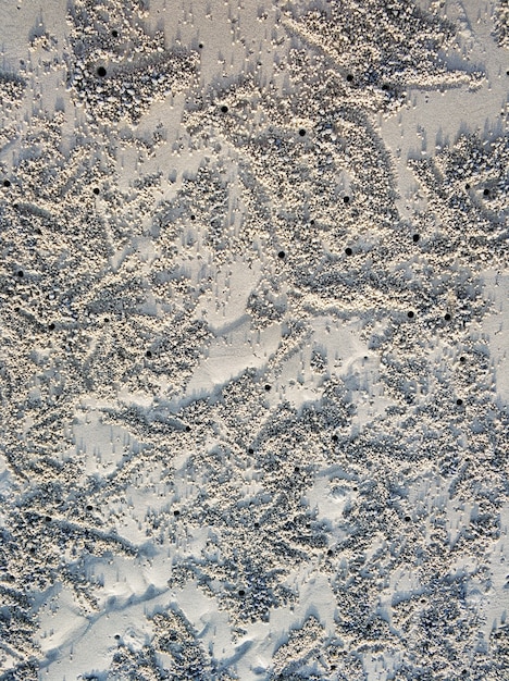 Wavy surface of the sandy ocean floor near the shore at low tide.