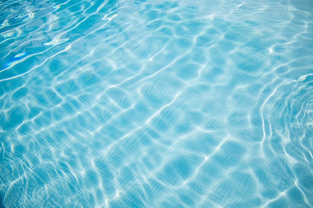 Wavy water surface of swimming pool Abstract closeup pool water summer vibes