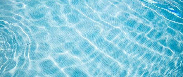 Wavy water surface of swimming pool Abstract closeup pool water summer vibes