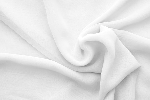 Wavy white chiffon fabric as texture or background twisted soft transparent cloth