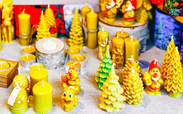 Wax candles at Christmas Market at Gendarmenmarkt square in Winter Riga, Latvia. Advent Fair Decoration and Stalls with Crafts Items on the Bazaar. Latvian street Xmas and holiday in European city