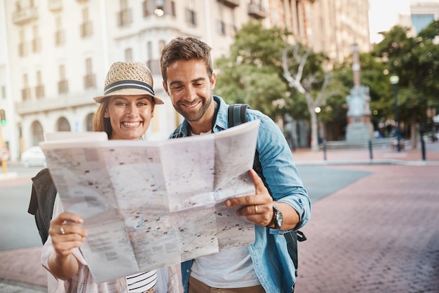 We both love exploring our surroundings Shot of a happy couple using a map while exploring a foreign city