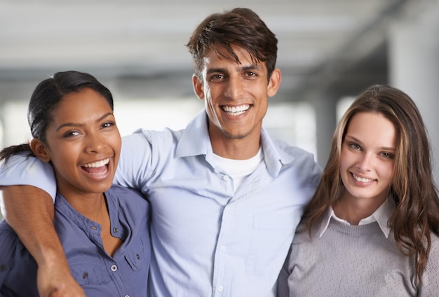 We have a fantastic work relationship A group of businesspeople embracing each other in the office