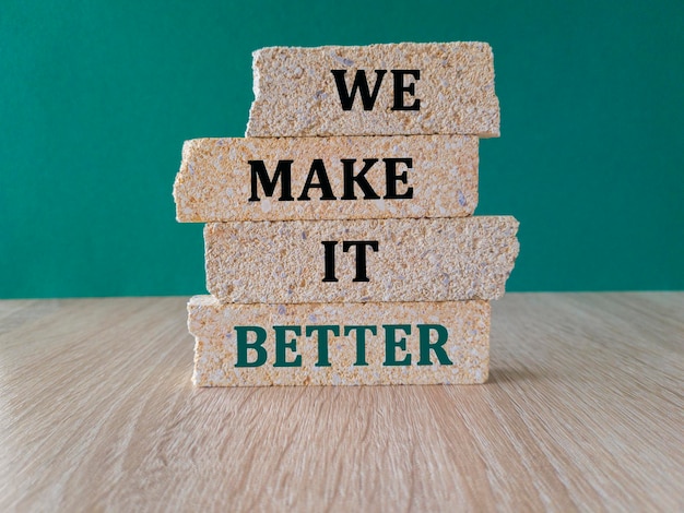 We make it better symbol Concept words We make it better on brick blocks Beautiful green background