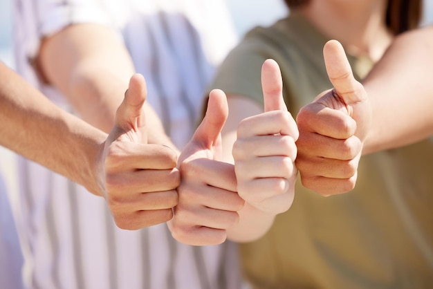 We support the cause Shot of a group of unrecognizable people showing a thumbs up outside