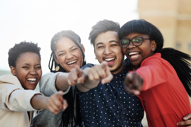 We want you Portrait of a group of happy students pointing toward the camera