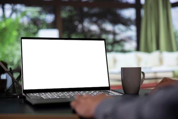 Wealthy shareholder relaxes in posh mountain chalet and looking at white screen